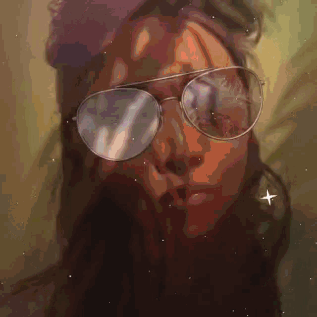 a woman wearing glasses and a beanie is surrounded by a colorful frame