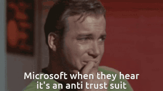 a man in a green shirt with the words microsoft when they hear it 's an anti trust suit