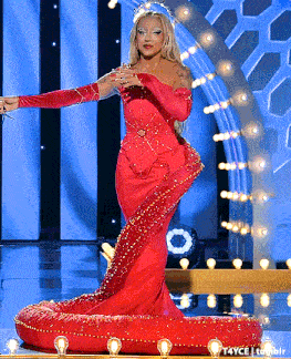 a woman in a long red dress is standing on a stage with lights behind her and the words t4yce tumblr below her