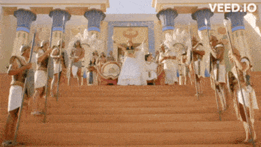 a group of people standing on a set of stairs with the word veed.io on the bottom left