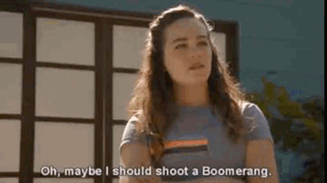 a woman is talking about shooting a boomerang .
