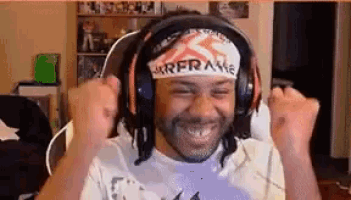 a man wearing headphones and a headband is making a fist in the air .