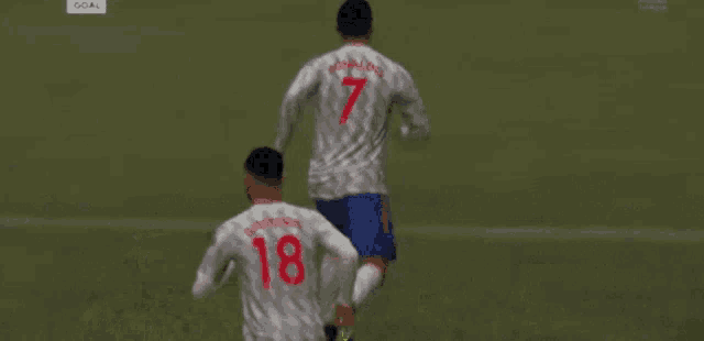 a soccer player with the number 18 on his jersey is laying on the ground
