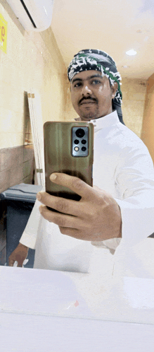 a man taking a picture of himself with a cellphone