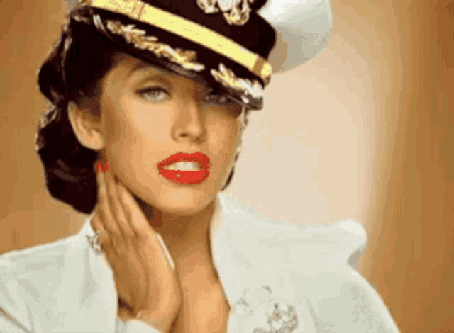 a woman wearing a military hat with gold trim