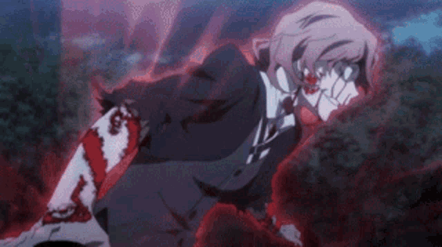 a man in a suit and tie with blood on his arm