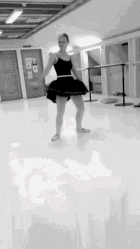a black and white photo of a ballerina dancing