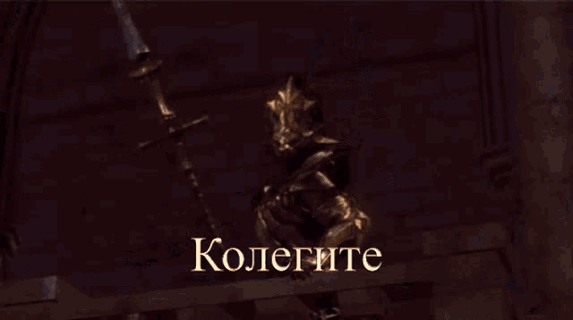a statue of a man holding a hammer with the word kolegite written on it