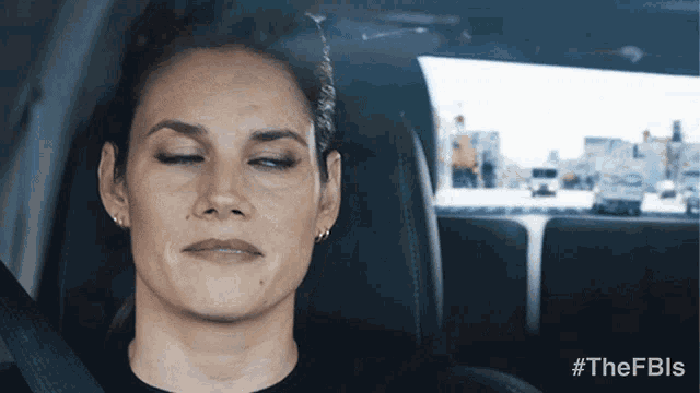 a woman in a car with her eyes closed and the hashtag #thefbls