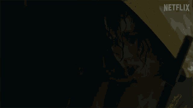 a woman in a yellow raincoat with a netflix logo on the bottom
