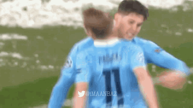 a blurry photo of two soccer players with the number 11 on their shirts