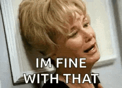a woman is leaning against a wall and crying with the words `` i 'm fine with that '' .