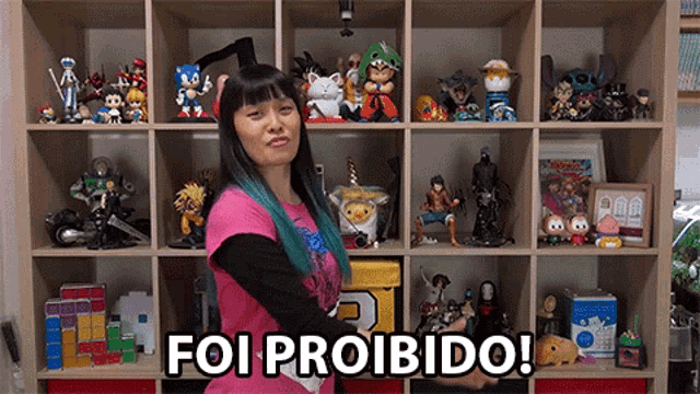 a woman standing in front of a shelf full of toys with the words foi proibido written on it