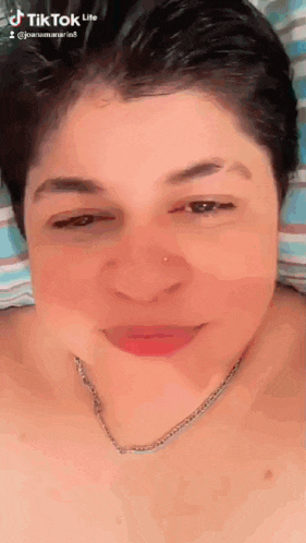a close up of a woman 's face with a tik tok lite watermark