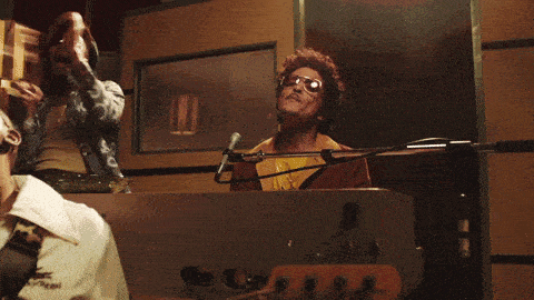 a man wearing sunglasses is playing a keyboard
