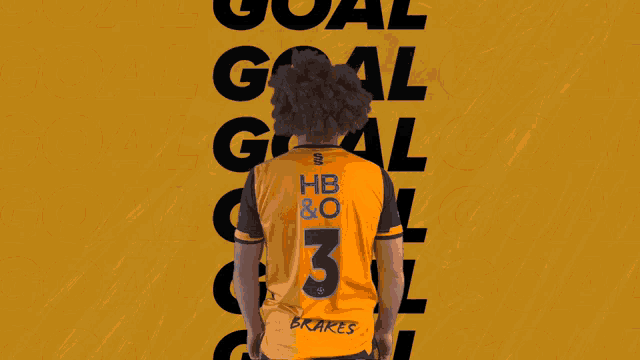 a man with a wig is standing in front of a yellow background with the words goal written on it