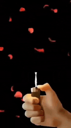 a hand is holding a lighter with a picture of a man in a white shirt coming out of it .