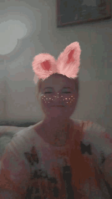 a woman wearing bunny ears and a butterfly shirt