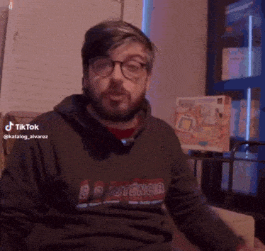 a man with a beard and glasses is wearing a black shirt with the word potencia on it