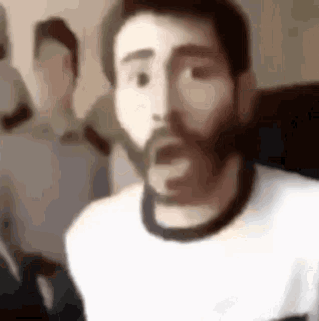 a man with a beard is wearing a white shirt