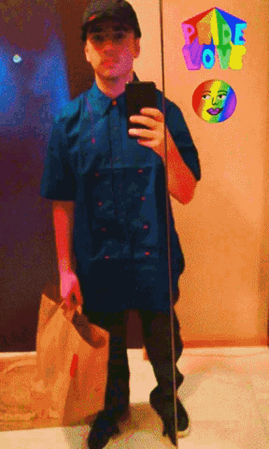 a man taking a picture of himself in front of a mirror with a rainbow sticker that says " pare love "