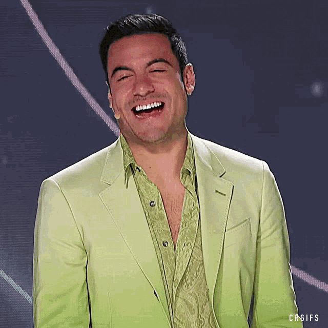 a man in a green suit is laughing with a caption that says crgifs