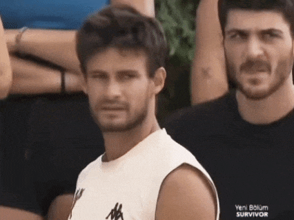 two men are standing next to each other and one has a shirt that says yeni bolum survivor on it .