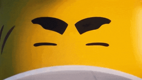 a close up of a yellow lego man 's face with black eyebrows and a beard .
