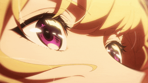 a close up of a girl 's eye with purple iris