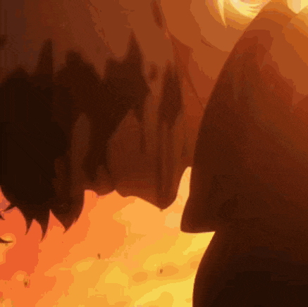 a silhouette of two people kissing in front of a fire .