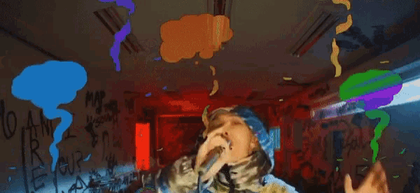 a person singing into a microphone in front of a wall that says pam