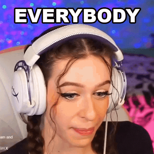a woman wearing headphones says " everybody " in black letters