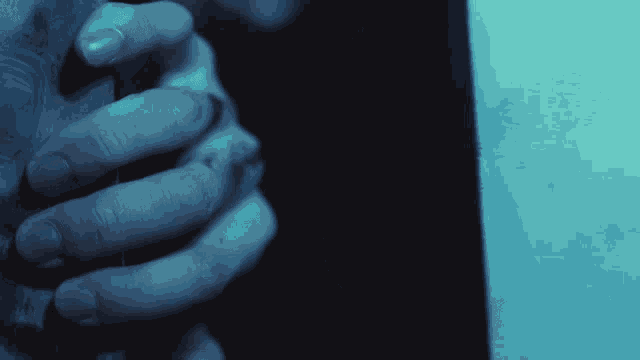 a person 's hands are visible in a dark room