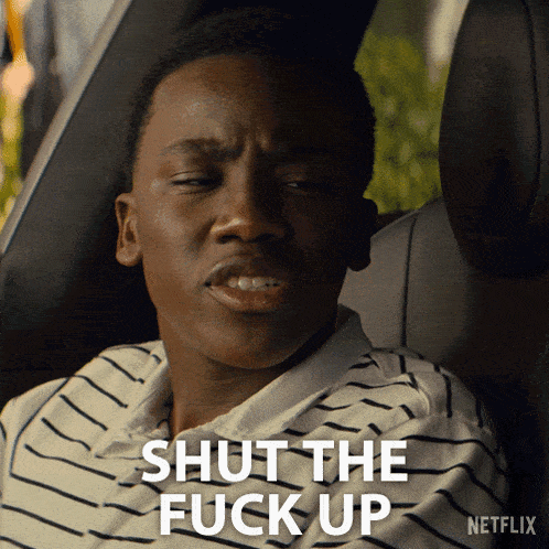 a man sitting in a car with the words shut the fuck up above him