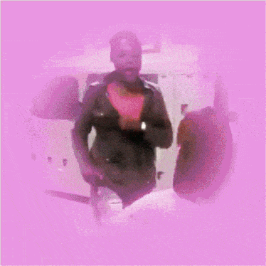 a man and woman are dancing in a room with a pink border
