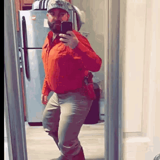 a man is taking a selfie in front of a mirror