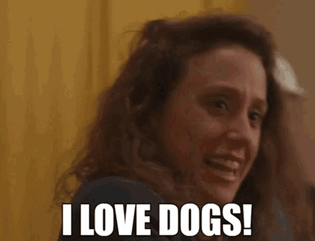 a woman is smiling and saying i love dogs
