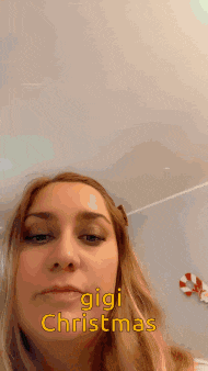 a close up of a woman 's face with the words gigi christmas written on it