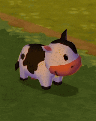 a black and white cow with a red nose is standing in a field