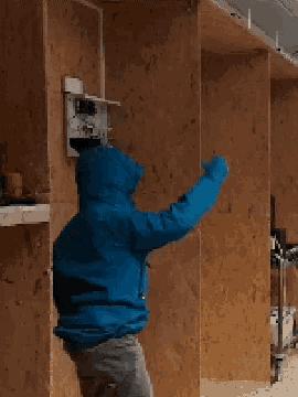 a man in a blue jacket is measuring something
