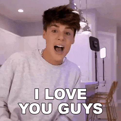 a young man in a gray sweater is saying i love you guys