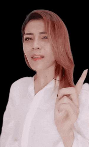 a woman with red hair is making a peace sign