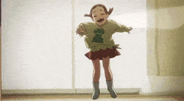 a little girl is jumping in the air with a frog on her shirt .