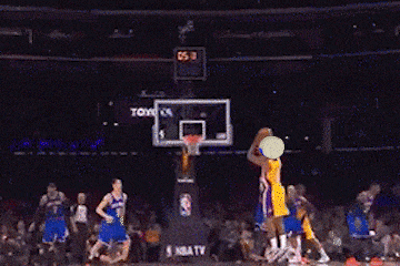 a basketball player wearing a lakers jersey is jumping for the ball