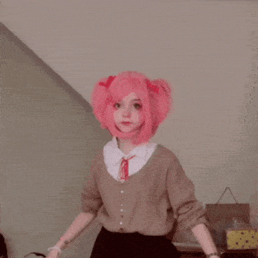 a person with pink hair is dancing in a room .