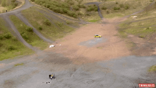 an aerial view of a dirt road with think jules written on the bottom right