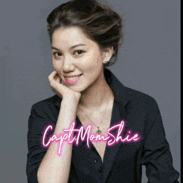 a woman in a black shirt with the name capt mom shie written in pink