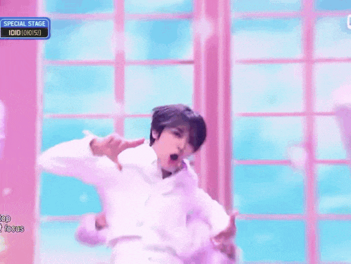 a man in a white shirt is dancing on a stage with a special stage sign above him