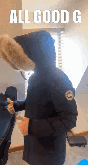 a picture of a person wearing a parka with the words all good g on it