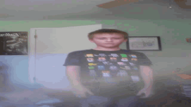 a boy wearing a shirt that says ' minecraft ' on it looks at the camera